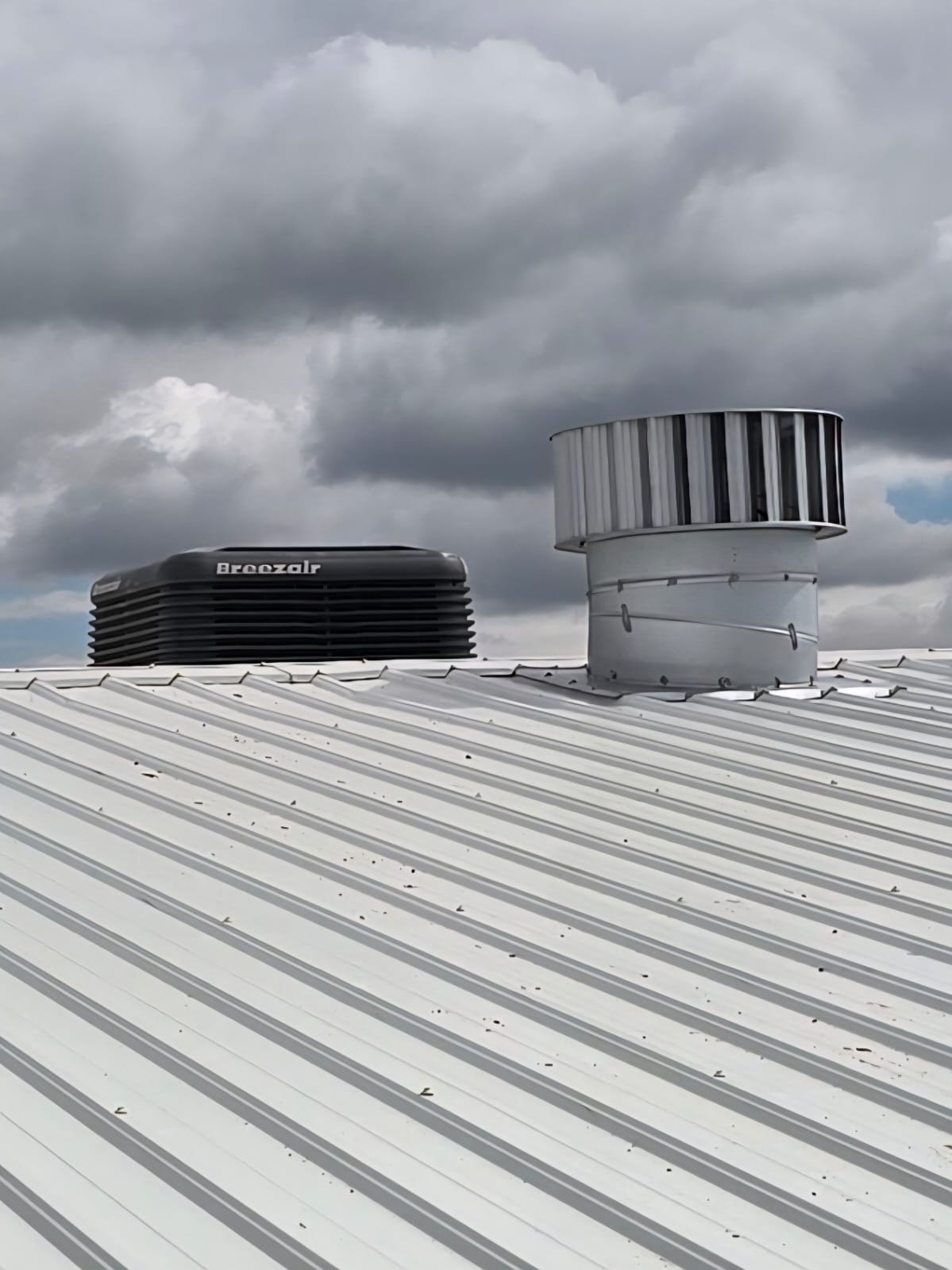 Breezeair evaporative cooler and turbine ventilator installed on corrugated roof — Airtech